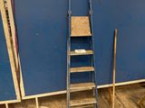 a ladder leaning against a blue wall in a room