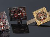 three different types of cufflinks are shown on a black surface