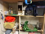 a small kitchen with a lot of clutter on the shelves