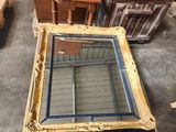 a table that has a mirror on it in the middle of a room