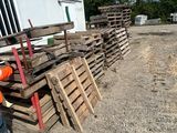 a man that is standing next to a pile of pallets