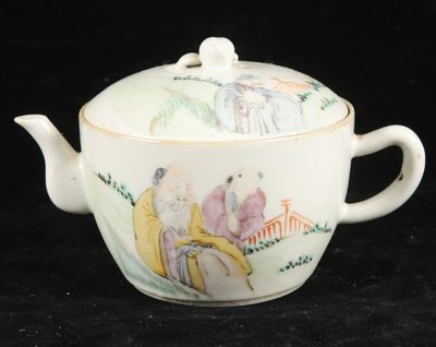 a tea pot with a lid that has a painting on it