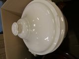 a white bowl sitting inside of a box with a lid