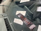 a sticker on the windshield of a car that has a price tag attached to it