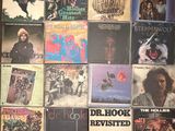 a bunch of records are stacked on top of each other on a table