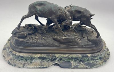 bronze sculpture of two boars fighting on a rock base