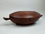 an image of a wooden bowl with carvings on it on a white surface