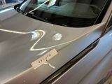 a sticker on the hood of a car that has a sticker on it