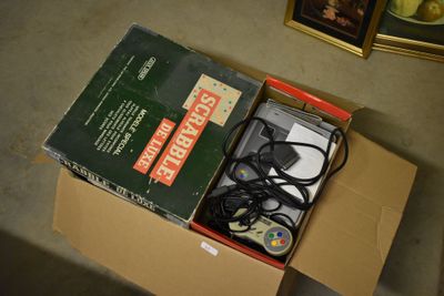 a box with a game controller inside of it on the floor