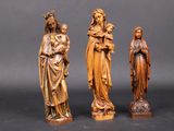 three wooden statues of jesus, mary, and jesus on a black background