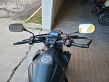a motorcycle parked in a garage with a mirror on it