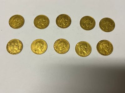 a bunch of gold coins sitting on top of a white table