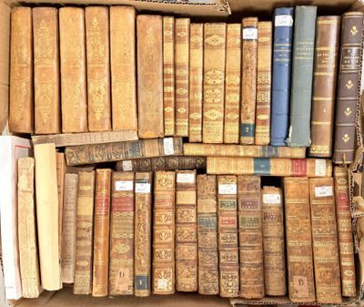 a box full of old books sitting on the floor