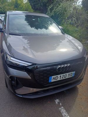 audi ' s new electric suv is parked on the side of the road