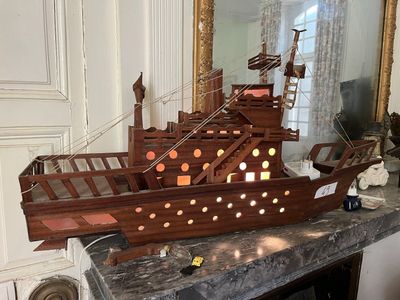 a wooden model of a pirate ship on a table