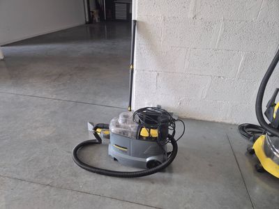 a yellow and black vacuum on the floor next to a yellow and black vacuum