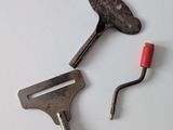 two tools that are sitting on a white surface