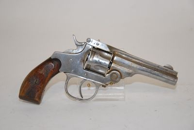 an old revolver with a wooden handle on a white surface