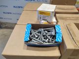 a box of screws sitting on top of a cardboard box