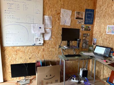 un bureau sur lequel sont posés un ordinateur portable et un écran, dans une pièce