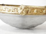 a white bowl with a gold decoration on it