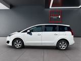 the small white car is parked in a large room