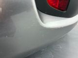 a close up of a car ' s rear bumper with a red light