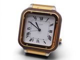 a gold and silver watch with roman numerals on the face