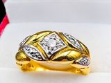 a close up of a gold ring with a diamond in it