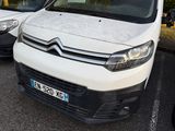 a white van parked in a parking lot next to other cars