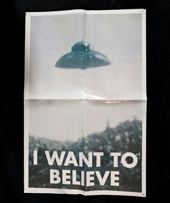 a poster with a picture of a flying saucer on it