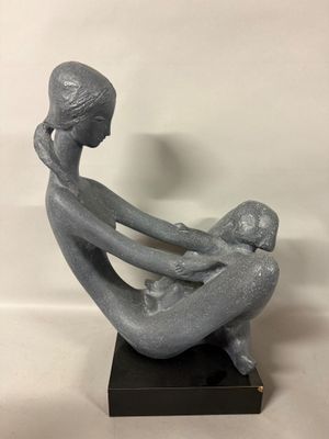 a statue of a woman holding a baby in her arms