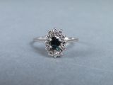 a close up of a ring with a blue diamond in it