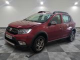 the red dacia is parked on a checkered tile floor