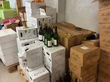boxes of wine are stacked on pallets in a room