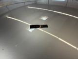 a picture of a parking garage with a sign on the floor