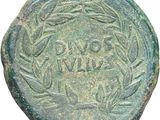 an ancient coin with a wreath on the reverse side
