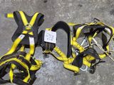 a pair of yellow and black harnesses laying on the ground