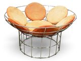 a metal basket with cookies in it on a white surface