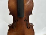 a violin that is sitting on a table next to a book