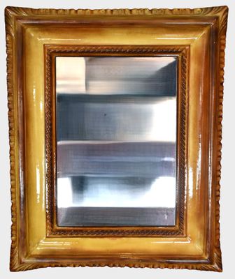 a picture of a gold framed mirror on the wall