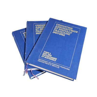 three blue books stacked on top of each other on a white surface