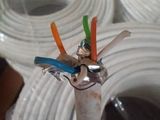 a white pipe that has a bunch of wires in it