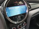 the interior of a car with a steering wheel and dashboard controls