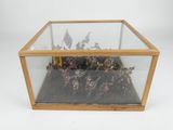 a glass display case with a bunch of small figurines inside of it