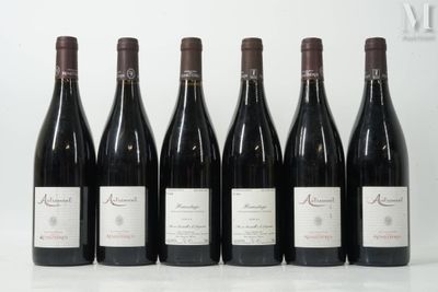 six bottles of wine are lined up in a row on a table