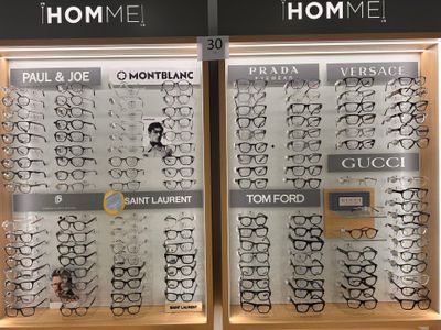 many pairs of glasses on display in a store window
