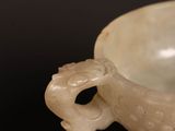 a white bowl sitting on top of a wooden table