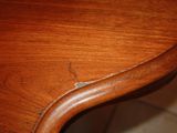 a close up of a wooden table with a brown stain on it