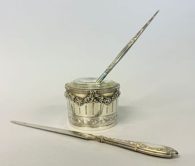 a silver spoon and a silver container with a spoon in it